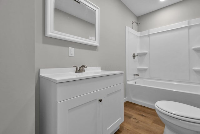 full bathroom with vanity, hardwood / wood-style floors, shower / tub combination, and toilet