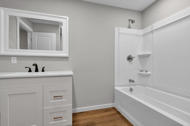 bathroom with vanity, hardwood / wood-style floors, and tub / shower combination