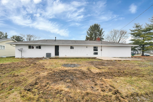 back of property featuring cooling unit, a yard, and a patio area