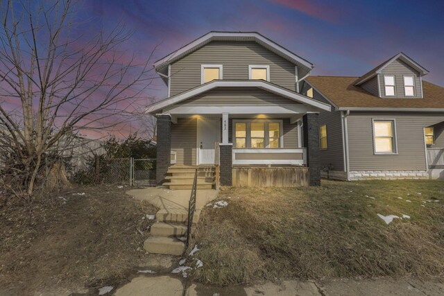 view of front facade featuring a lawn and a porch