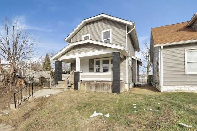 view of front of home featuring a front yard and covered porch