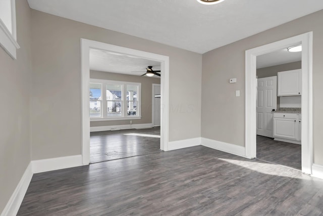 spare room featuring ceiling fan and dark hardwood / wood-style floors