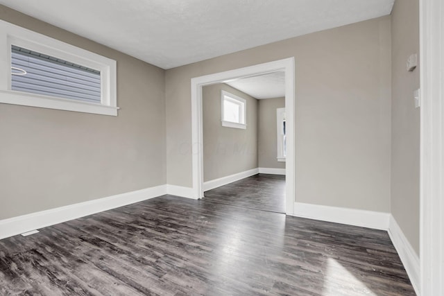 unfurnished room featuring dark hardwood / wood-style flooring