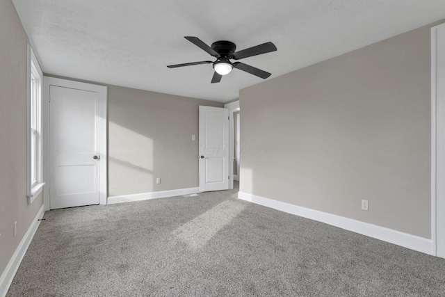 unfurnished room with carpet floors and ceiling fan