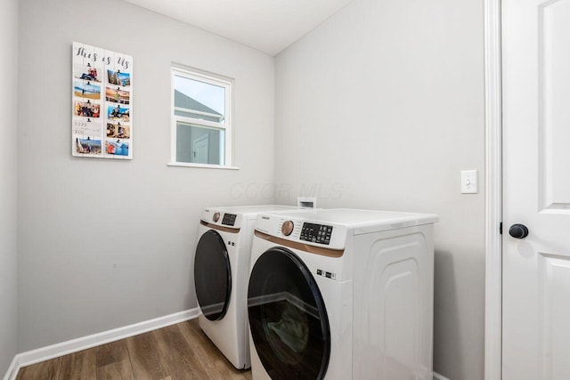 laundry area with dark wood-type flooring and washing machine and clothes dryer