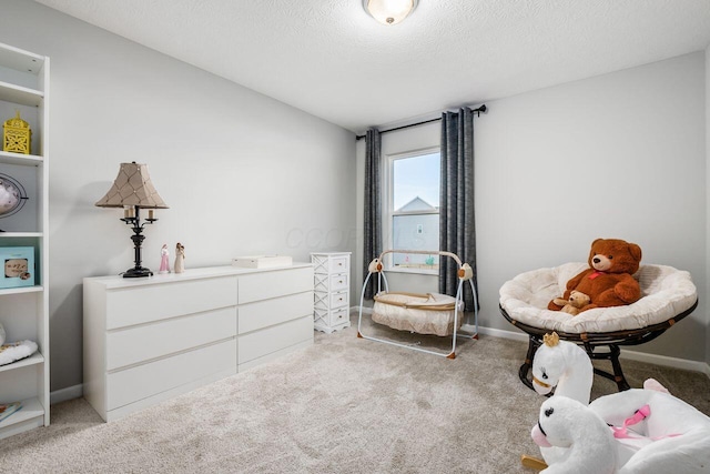 interior space featuring light colored carpet and a textured ceiling