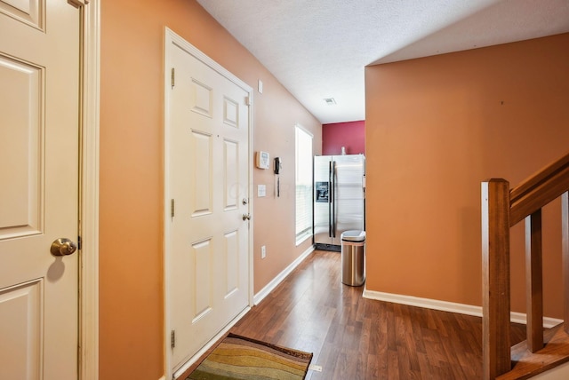 hall with dark hardwood / wood-style floors and a textured ceiling