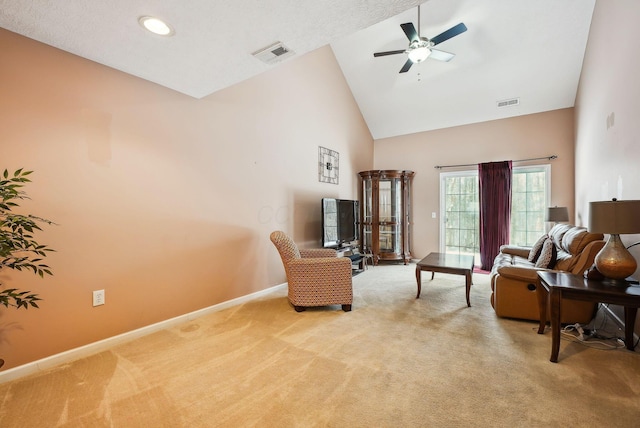 carpeted living room with high vaulted ceiling and ceiling fan