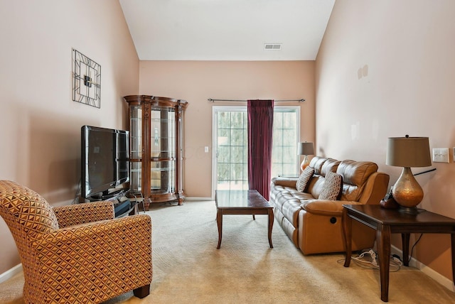 carpeted living room with lofted ceiling