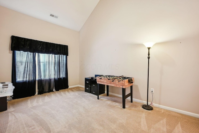 interior space with lofted ceiling and light colored carpet