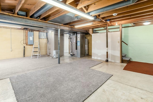 basement with heating unit, gas water heater, and electric panel