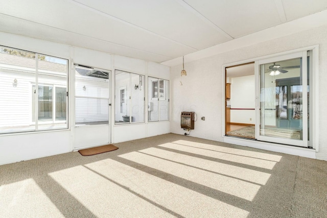 carpeted empty room featuring heating unit