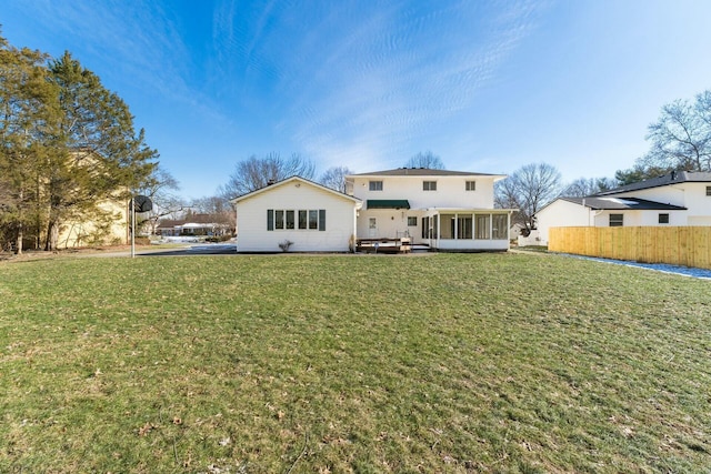 back of house with a yard and a sunroom