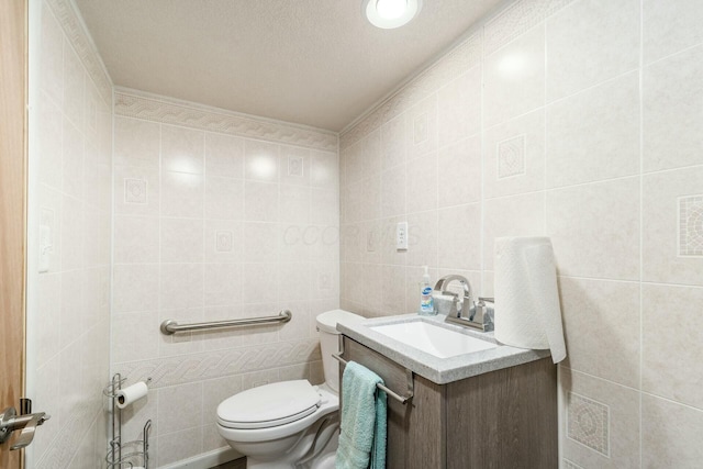 bathroom featuring tile walls, vanity, and toilet