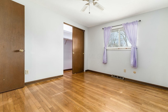 unfurnished bedroom featuring ceiling fan, a closet, and light hardwood / wood-style flooring