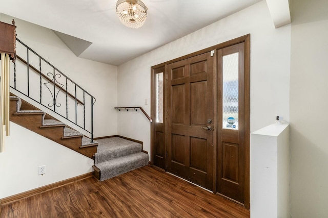 entrance foyer featuring dark wood-type flooring and a chandelier