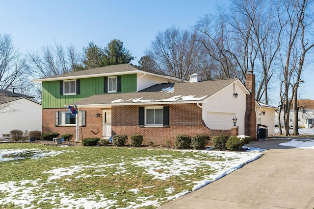 front of property featuring a garage, central AC unit, and a front lawn