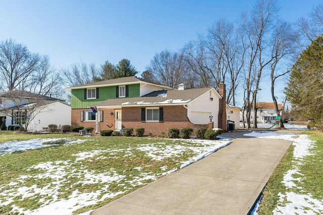 front facade featuring a garage and a front yard