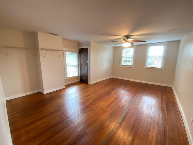 interior space featuring dark wood-type flooring and ceiling fan