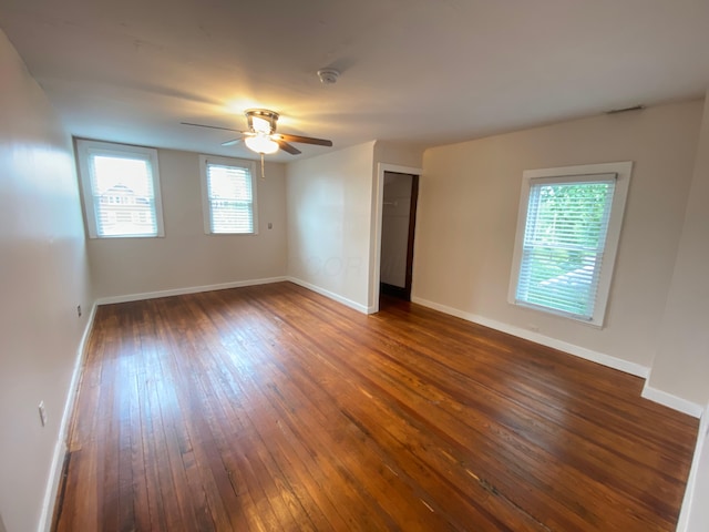 spare room featuring dark hardwood / wood-style floors and ceiling fan