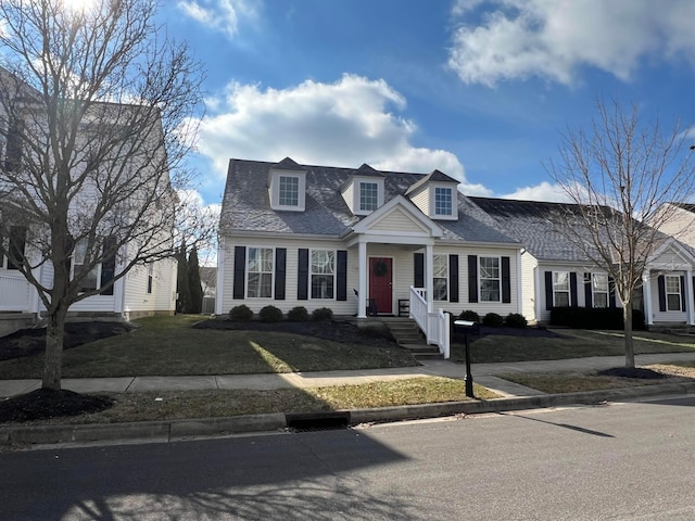 cape cod-style house featuring a front yard