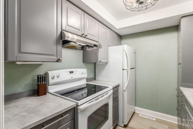 kitchen with light wood-type flooring, gray cabinets, and white electric range oven