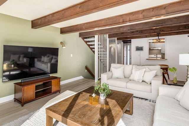 living room featuring beam ceiling and wood-type flooring