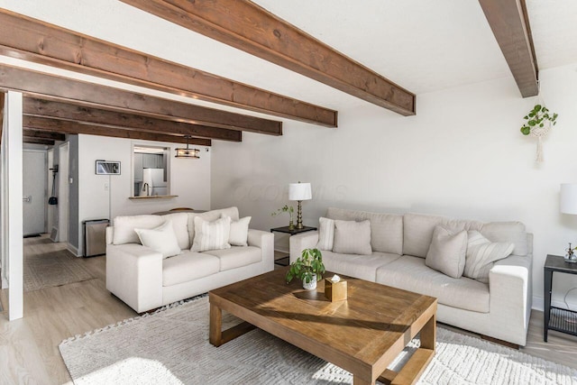 living room with beam ceiling and light hardwood / wood-style floors