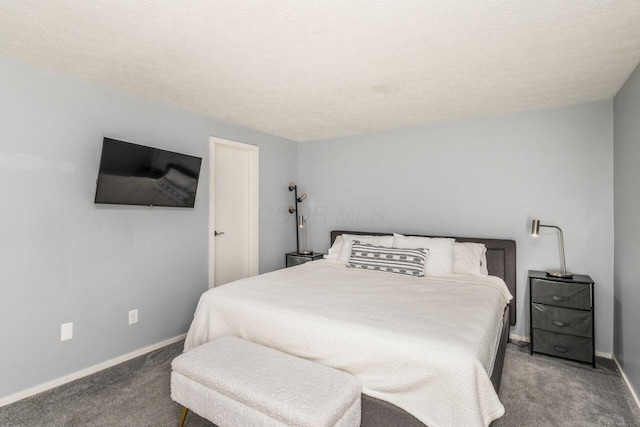 carpeted bedroom featuring a textured ceiling