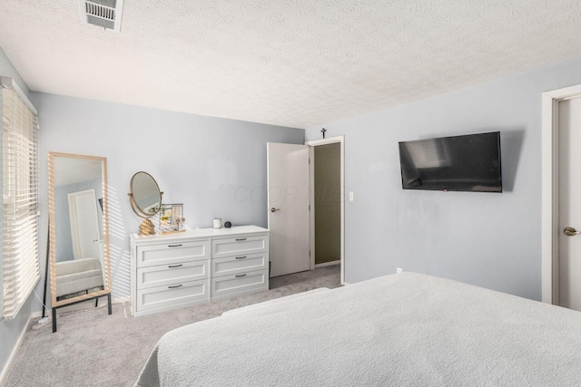 carpeted bedroom featuring a textured ceiling