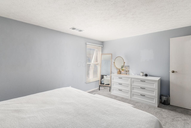 carpeted bedroom with a textured ceiling