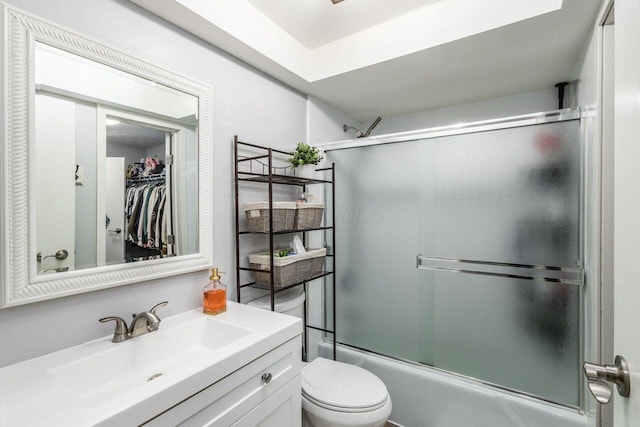 full bathroom with vanity, combined bath / shower with glass door, and toilet