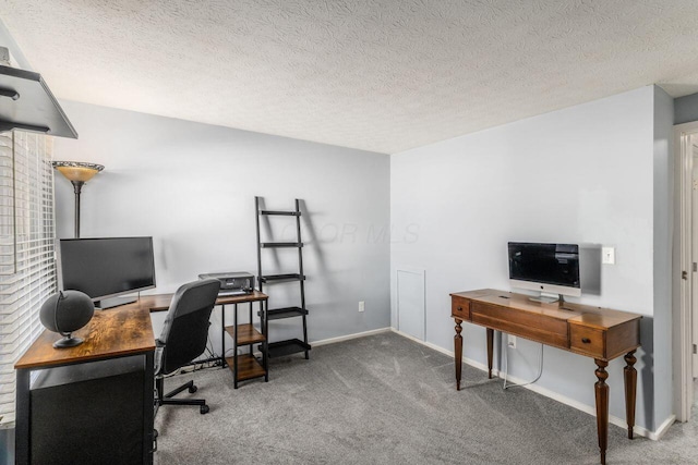 carpeted office featuring a textured ceiling