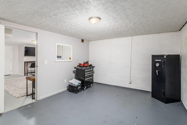 basement featuring a textured ceiling