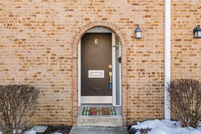 view of snow covered property entrance