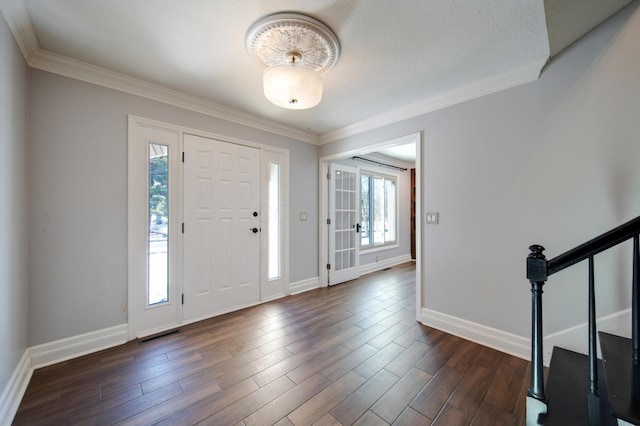 foyer featuring crown molding and dark hardwood / wood-style flooring