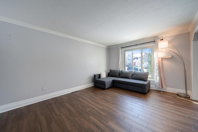 unfurnished living room featuring dark wood-type flooring, crown molding, and a textured ceiling