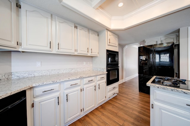 kitchen with white cabinetry, crown molding, light hardwood / wood-style floors, and black appliances