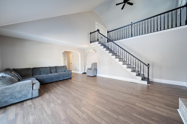 living room featuring ceiling fan and high vaulted ceiling