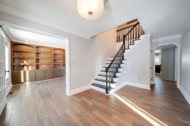 interior space featuring crown molding and built in features