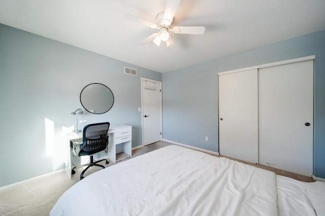 carpeted bedroom featuring ceiling fan and a closet