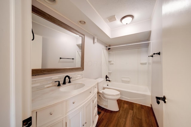 full bathroom featuring tasteful backsplash, vanity, wood-type flooring, shower / bathtub combination, and toilet