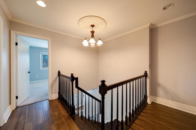 stairs featuring crown molding and a chandelier