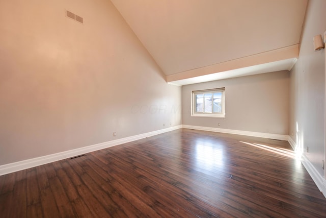 empty room featuring dark hardwood / wood-style floors and high vaulted ceiling