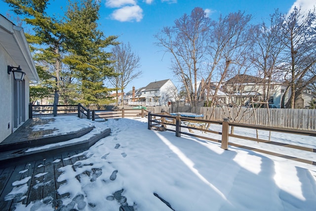 yard covered in snow featuring a wooden deck