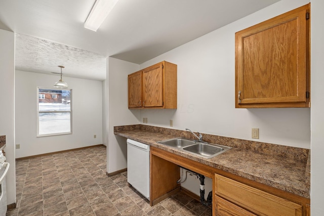 kitchen with pendant lighting, white dishwasher, range, and sink