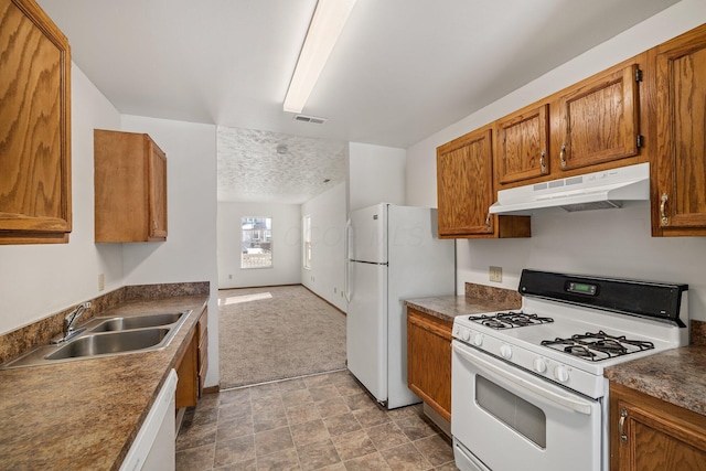 kitchen featuring sink, light colored carpet, and white appliances