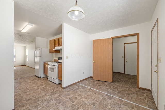 kitchen with white appliances and a textured ceiling