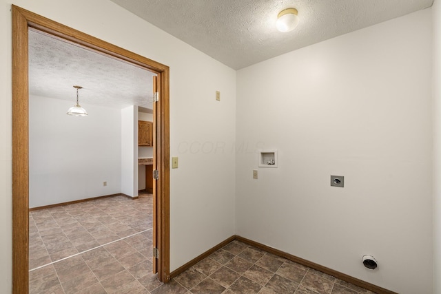 laundry area with hookup for a washing machine, a textured ceiling, and electric dryer hookup