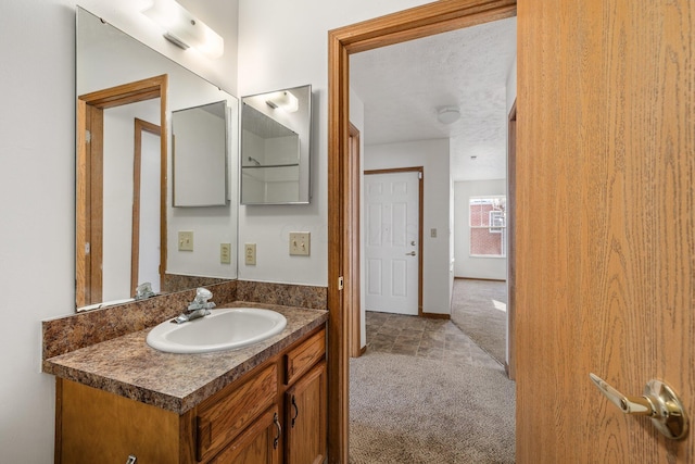 bathroom with vanity and a textured ceiling